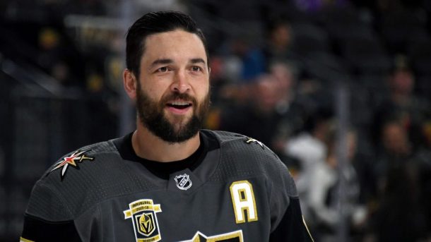 Deryk Engelland, an alternate captain for the Vegas Golden Knights, smiles on home ice as he talks with his teammates